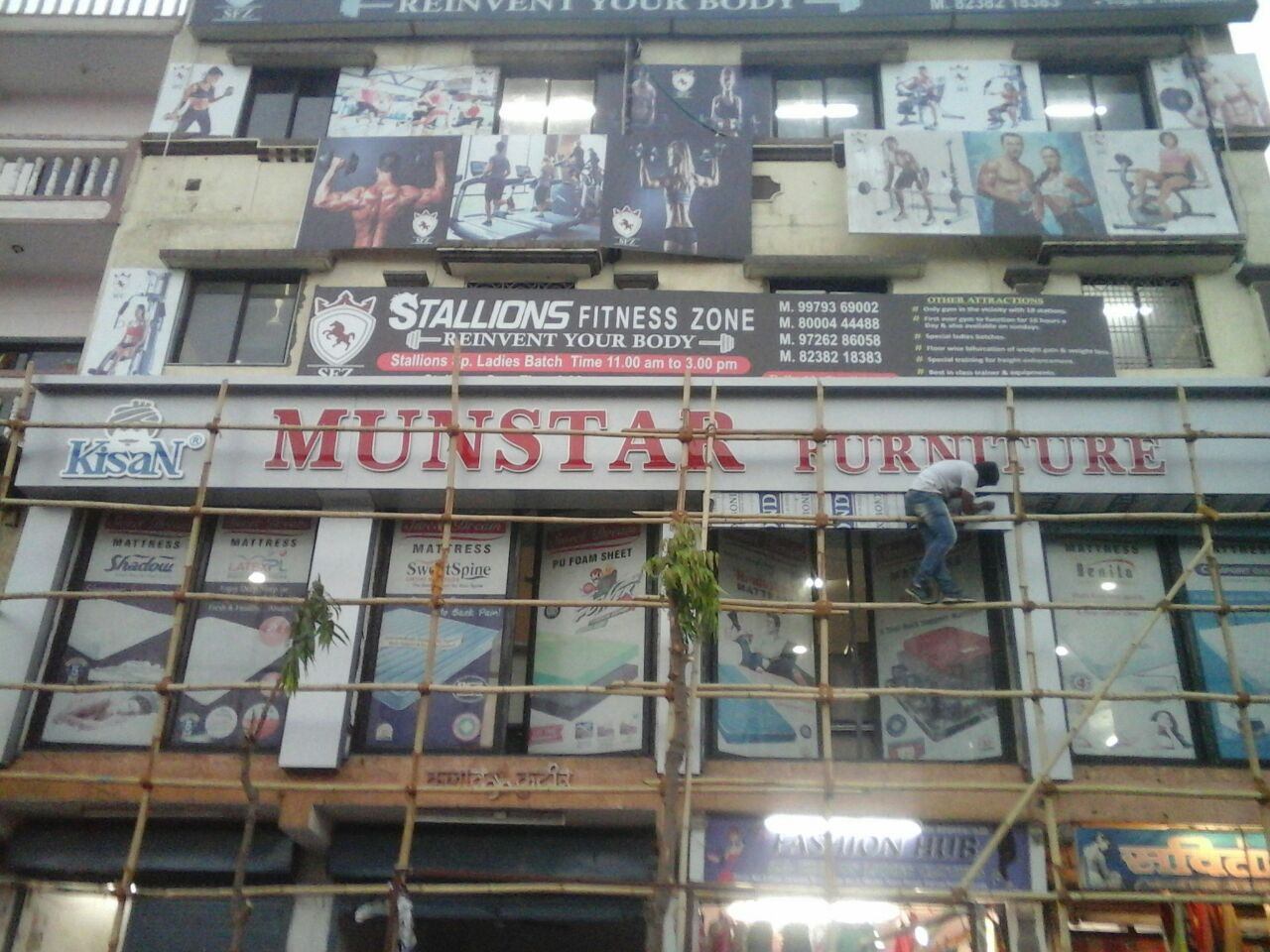 Multi Plus crew installing a shop fascia board from scaffolding
